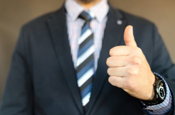 businessman in suit thumbs up